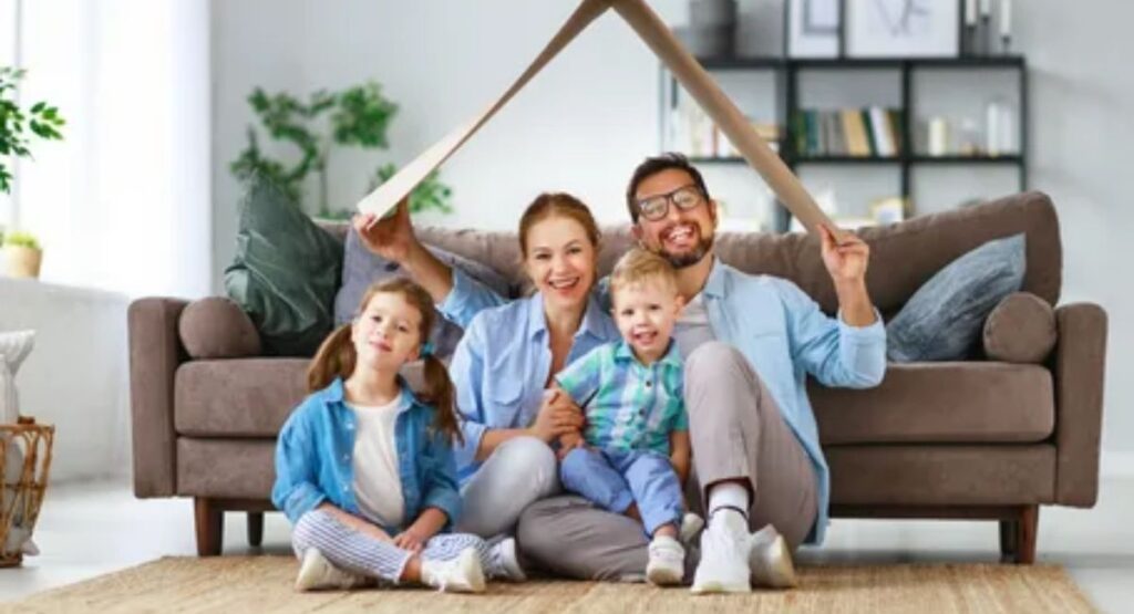 Heartwarming wishes for parents shown by a smiling child giving a handwritten card and flowers to loving mother and father in a cozy sunlit living room.
